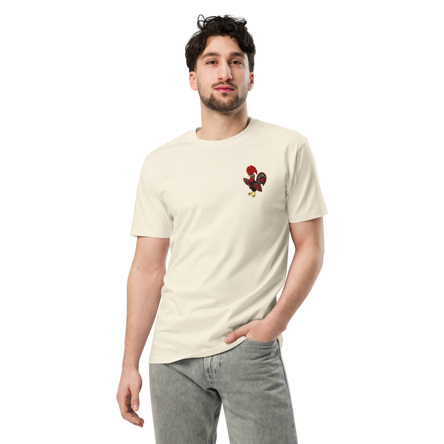 Close up of the Galo de Barcelos chest embroidery on a natural RAIZ tee